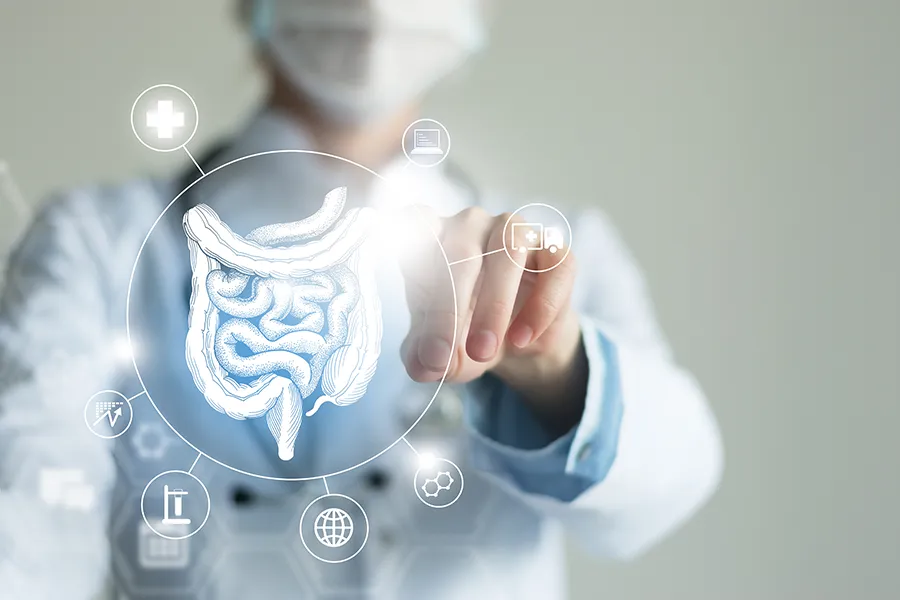 Leaky-Gut-Syndrome-Clinic Tanya Zboril, NP of TBT Medical provides advanced Functional Medicine for Leaky Gut Syndrome treatments in Regina, shown by a doctor touching a glowing digital intestinal health display.