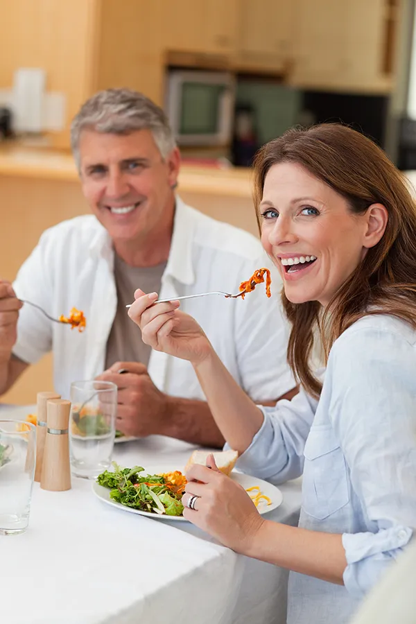 Leaky-Gut-Syndrome-Treatment Improve digestion with Tanya Zboril, NP of TBT Medical's Functional Medicine for Leaky Gut Syndrome care in Regina, featuring a happy couple enjoying a nutritious lunch at home.