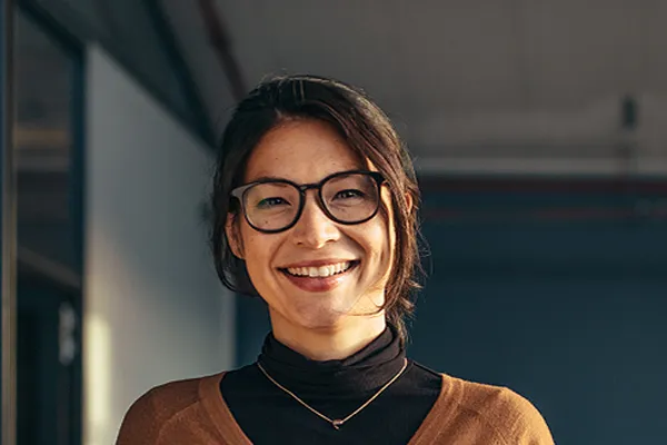 Metabolic-Syndrome-Clinic A brunette woman with glasses smiles in a gray-blue walled office. Get metabolic syndrome from Tanya Zboril, NP of TBT Medical in Regina.