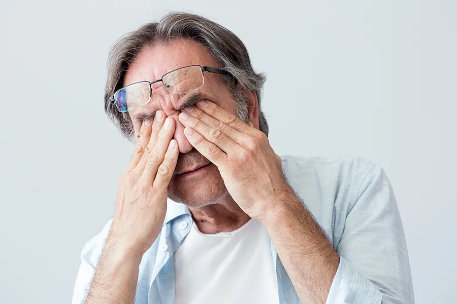 Migraine-Clinic Get migraine relief with Tanya Zboril, NP of TBT Medical's functional medicine for migraines treatment in Regina, represented by an older man rubbing his eyes due to head pain.